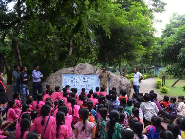 Seen here are schoolchildren listening to an instructor at the dinosaur park. (AFP)