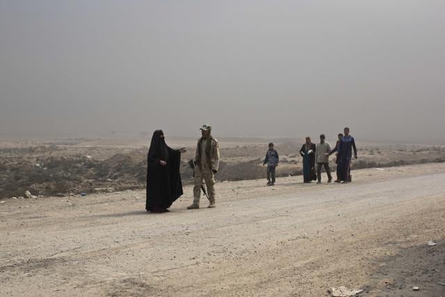 A woman talks to an Iraqi army soldier at a checkpoint in Qayara, some 50 kilometers south of Mosul, Iraq, Wednesday, Oct. 26, 2016. (AP) A woman talks to an Iraqi army soldier at a checkpoint in Qayara, some 50 kilometers south of Mosul, Iraq, Wednesday, Oct. 26, 2016. (AP)