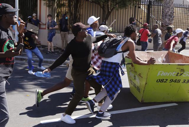 Students run toward South African Police during a protest outside parliament in Cape Town, South Africa, Wednesday, Oct. 26, 2016. (AP) Students run toward South African Police during a protest outside parliament in Cape Town, South Africa, Wednesday, Oct. 26, 2016. (AP)