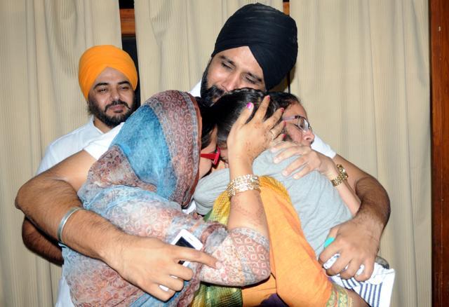 The family hugging the child in Patiala on Wednesday. (Bharat Bhushan/HT Photo)