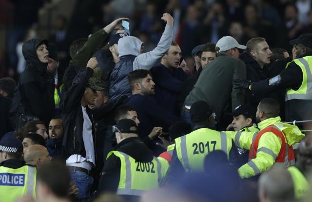 Rival supporters taunt each other and clash with stewards during the match. (AP) Rival supporters taunt each other and clash with stewards during the match. (AP)