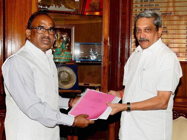 Justice L Narasimha Reddy, chairman of the Judicial Committee on OROP, handing over the report to the defence minister Manohar Parrikar in South Block, New Delhi on Wednesday. (PTI)