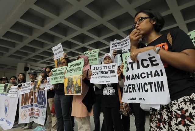 A migrant workers alliance group holds placards to protest the killings of two Indonesian women in 2014 outside the high court in Hong Kong. (AP Photo) A migrant workers alliance group holds placards to protest the killings of two Indonesian women in 2014 outside the high court in Hong Kong. (AP Photo)