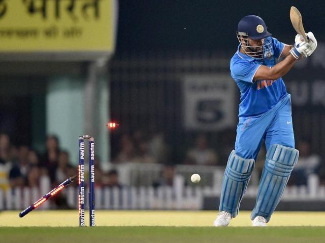 The bails fly off as MS Dhoni is bowled by James Neesham. (PTI)