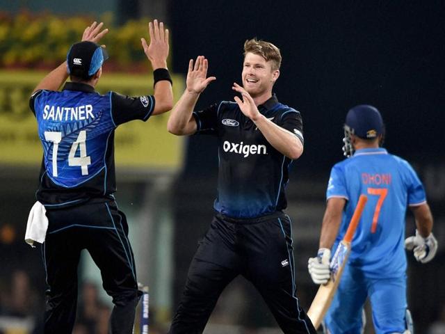 James Neesham, centre, celebrates with Mitchell Santner after dismissing M S Dhoni. (PTI)