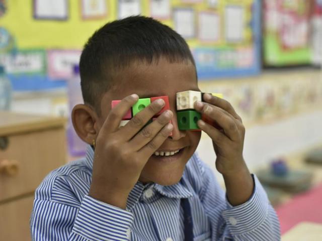 A child plays in the newly inaugurated smart classroom at municipal corporation primary school. Lieutenant governor of Delhi, Najeeb Jung, visited Ark organisation and later toured the school where he inaugurated a new library and a smart technology classroom. (Vipin Kumar/HT PHOTO)