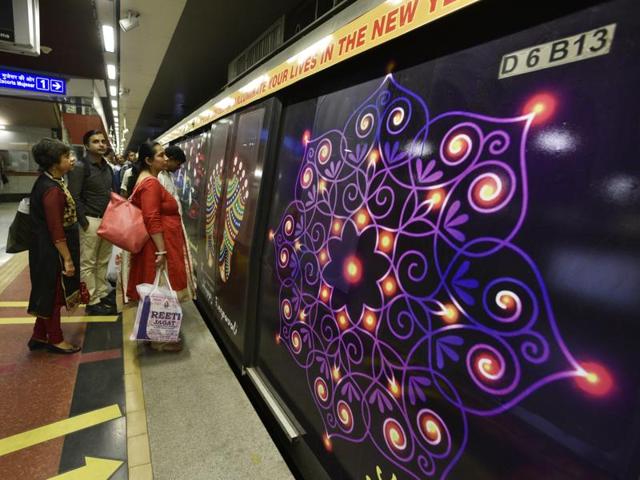 An image of a traditional ‘rangoli’ on the Delhi metro train. (Sanjeev Verma/HT Photo)