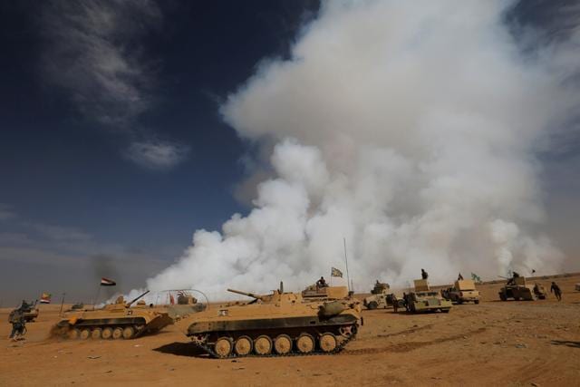 Iraqi army gather after the liberation of a village from Islamic State militants, south of Mosul. (Reuters Photo) Iraqi army gather after the liberation of a village from Islamic State militants, south of Mosul. (Reuters Photo)