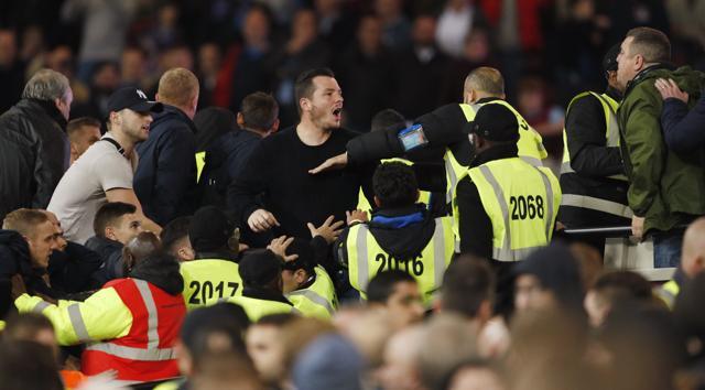 West Ham United's fans clash with Chelsea supporters. (REUTERS)