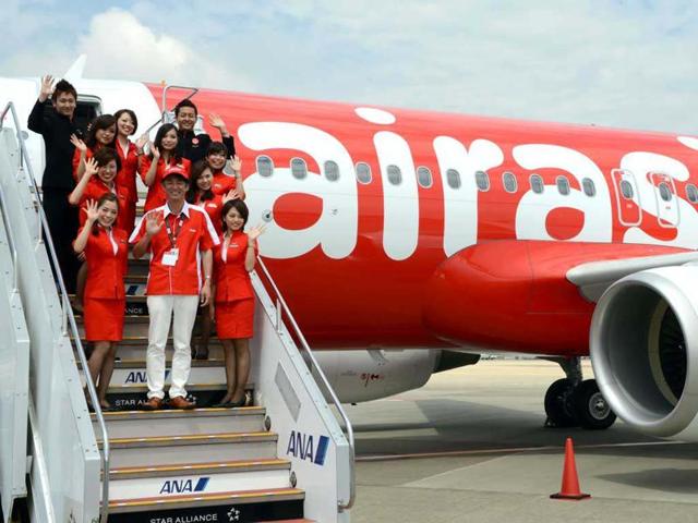 Air-Asia-Japan-President-Kazuyuki-Iwakata-front-C-and-his-company-s-cabin-attendants-wave-during-a-photo-session-with-newly-designed-Airbus-A320-at-the-Narita-International-airport-AFP-photo-Toshifumi-Kitamura Air-Asia-Japan-President-Kazuyuki-Iwakata-front-C-and-his-company-s-cabin-attendants-wave-during-a-photo-session-with-newly-designed-Airbus-A320-at-the-Narita-International-airport-AFP-photo-Toshifumi-Kitamura
