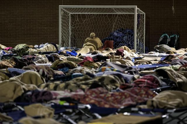 Residents rest in a sport center where they found a temporary shelter in the town of Camerino, central Italy. (AP Photo)