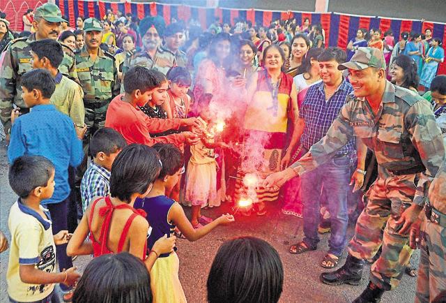 Children along with soldiers celebrate Diwali with fire-crackers at Army Cantonment area near Beawar on Thursday. (PTI Photo) Children along with soldiers celebrate Diwali with fire-crackers at Army Cantonment area near Beawar on Thursday. (PTI Photo)