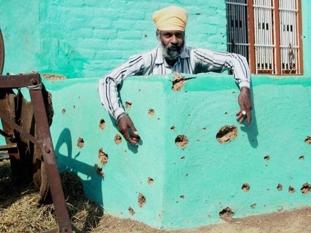 Children stand near the pockmarked wall of a building damaged by alleged shelling from the Pakistani side at R.S pura, in Jammu, on Thursday, October 27, 2016. BSF said it had killed 15 Pakistani paramilitary personnel in retaliatory firing, a claim denied by Pakistan Army. (Nitin Kanotra / HT Photo) Children stand near the pockmarked wall of a building damaged by alleged shelling from the Pakistani side at R.S pura, in Jammu, on Thursday, October 27, 2016. BSF said it had killed 15 Pakistani paramilitary personnel in retaliatory firing, a claim denied by Pakistan Army. (Nitin Kanotra / HT Photo)