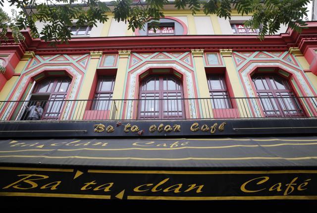A man appears on a balcony of the renovated facade of the Bataclan concert hall in Paris. (AP Photo)