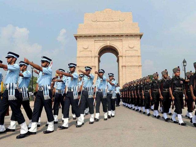 Indian armed forces personnel march past India Gate in New Delhi. The government has decided to form a panel to look into the issue of civil-military rank disparity. (File Photo) Indian armed forces personnel march past India Gate in New Delhi. The government has decided to form a panel to look into the issue of civil-military rank disparity. (File Photo)