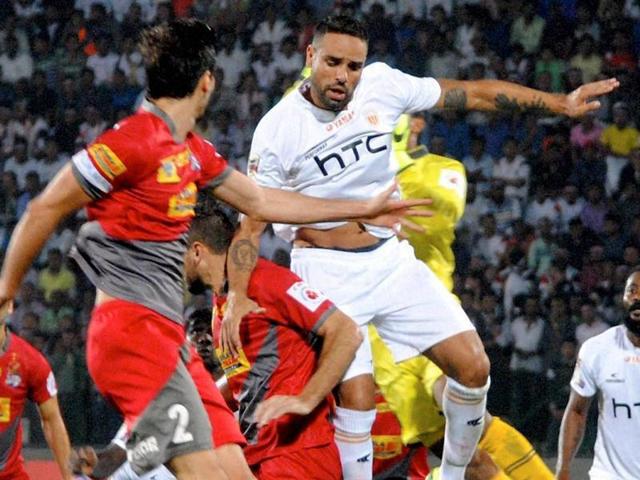 Players of Northeast United FC (in white jersey) and Atletico de Kolkata (in red jersey) vie for the ball. (PTI Photo) Players of Northeast United FC (in white jersey) and Atletico de Kolkata (in red jersey) vie for the ball. (PTI Photo)