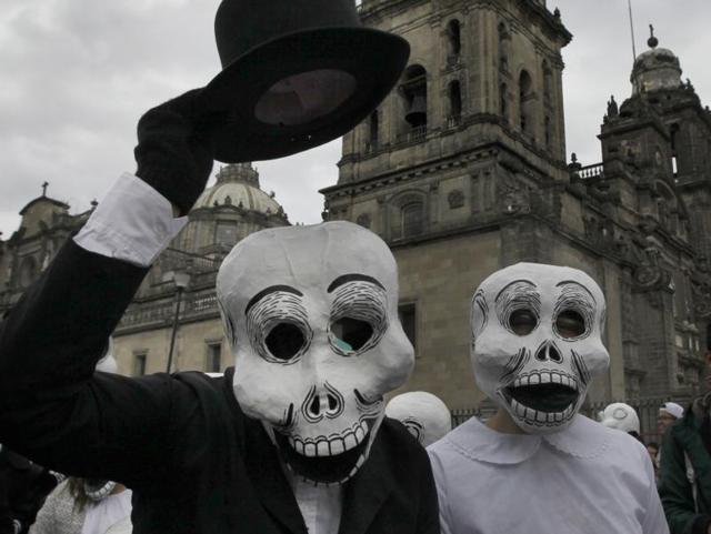 A couple wearing skull masks perform at the festival. (AP) A couple wearing skull masks perform at the festival. (AP)