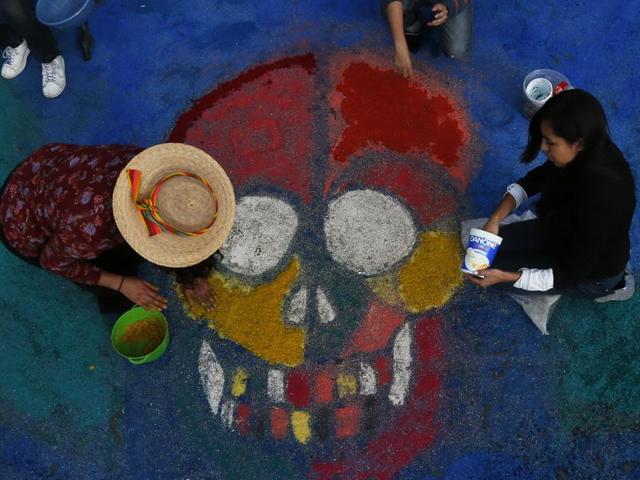 Residents create a sawdust representation of a skull. (AP) Residents create a sawdust representation of a skull. (AP)