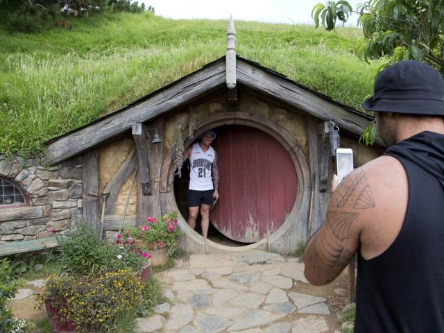 Tourists take photos during a tour of the Hobbit movie set near Matamata, New Zealand. In New Zealand there are twice as many cows as people, but it's the hobbits that are really making hay. According to figures released Wednesday, Oct. 26, 2016, tourism has overtaken dairy as the nation's top earner of overseas dollars. And tourism officials say the success of the fantasy movie trilogy The Hobbit has helped. (AP) Tourists take photos during a tour of the Hobbit movie set near Matamata, New Zealand. In New Zealand there are twice as many cows as people, but it's the hobbits that are really making hay. According to figures released Wednesday, Oct. 26, 2016, tourism has overtaken dairy as the nation's top earner of overseas dollars. And tourism officials say the success of the fantasy movie trilogy The Hobbit has helped. (AP)