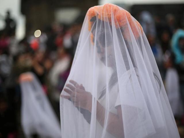 A girl with her face painted to look like the popular Mexican figure called "Catrina" take part in a procession. (REUTERS) A girl with her face painted to look like the popular Mexican figure called "Catrina" take part in a procession. (REUTERS)