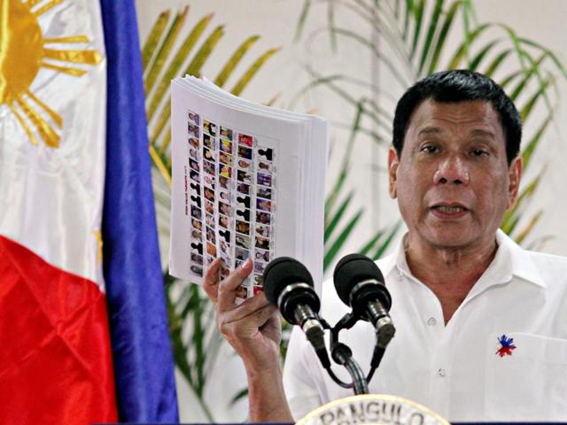 Philippine President Rodrigo Duterte shows the list of government, military and police officials involved in illegal drug trade during a news conference. (REUTERS) Philippine President Rodrigo Duterte shows the list of government, military and police officials involved in illegal drug trade during a news conference. (REUTERS)