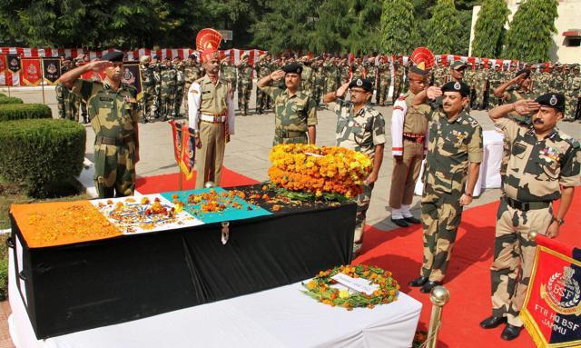 BSF officials pay floral tributes to soldier Sushil Kumar, who lost his life in firing by Pakistan, during a wreath laying ceremony at BSF's Paloura Camp in Jammu on Monday. (PTI)