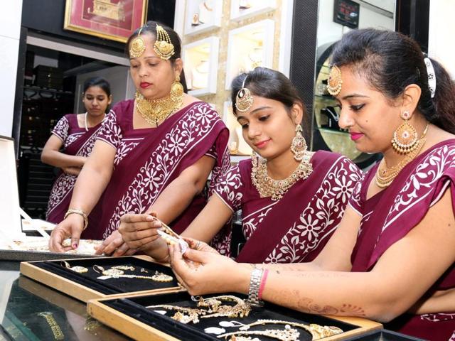 Employee busy at a jewellery shop on Dhanteras in Bathinda on Friday. (Sanjeev Kumar/HT Photo)