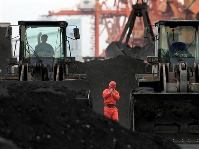 An employee walks between front-end loaders which are used to move coal imported from North Korea at Dandong port in the Chinese border city of Dandong, Liaoning province. (REUTERS) An employee walks between front-end loaders which are used to move coal imported from North Korea at Dandong port in the Chinese border city of Dandong, Liaoning province. (REUTERS)