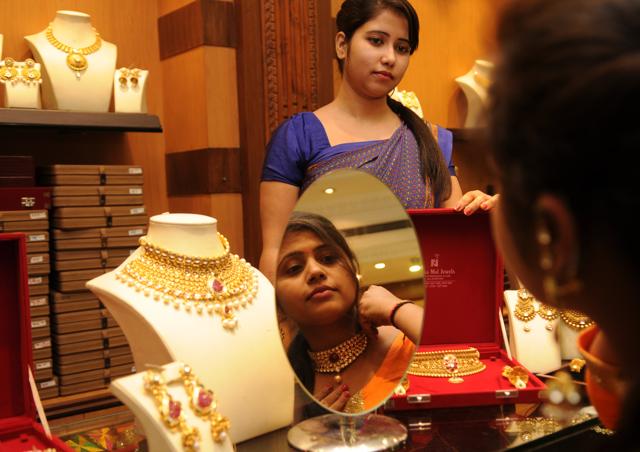 A woman tries on a necklace on Dhanteras, in Jalandhar on Friday. (HT Photo) 