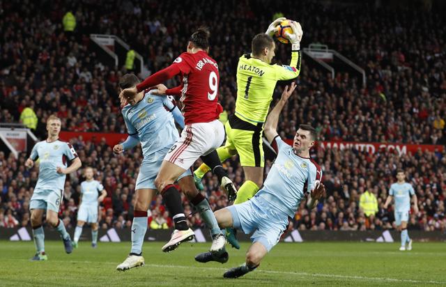 Burnley's Tom Heaton in action with Manchester United's Zlatan Ibrahimovic. (REUTERS) Burnley's Tom Heaton in action with Manchester United's Zlatan Ibrahimovic. (REUTERS)