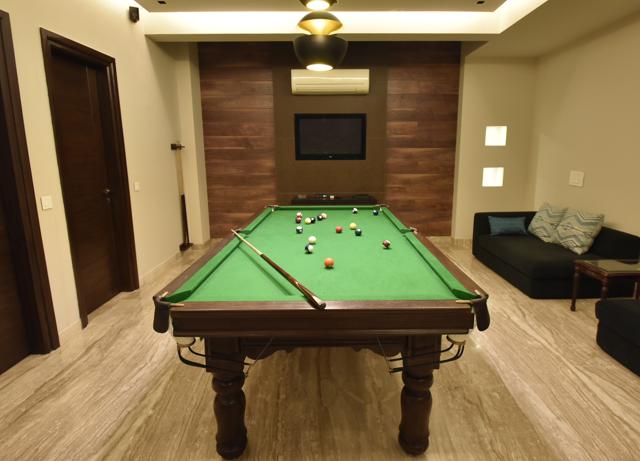 The basement has been transformed into a casual, recreational zone with the pool table and a home theatre thrown in. (Ravi Choudhary/HT PHOTO)