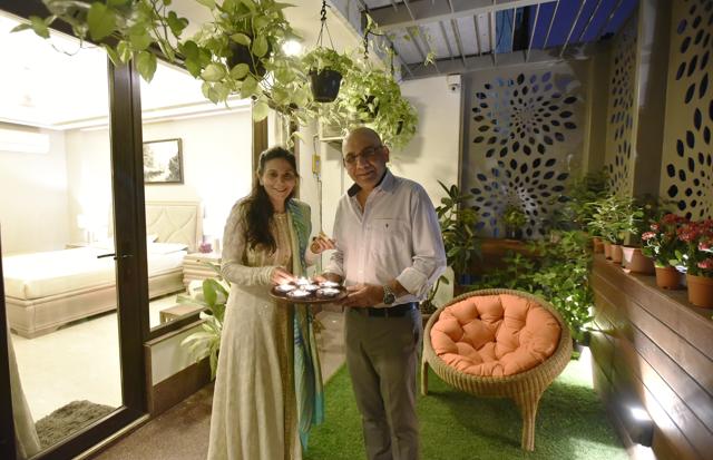 Entrepreneur Pawan and his wife Tanu celebrating Diwali in their new house. Their balcony has been done up with interesting orange chairs , faux grass and lots of plants. (Ravi Choudhary/HT PHOTO)