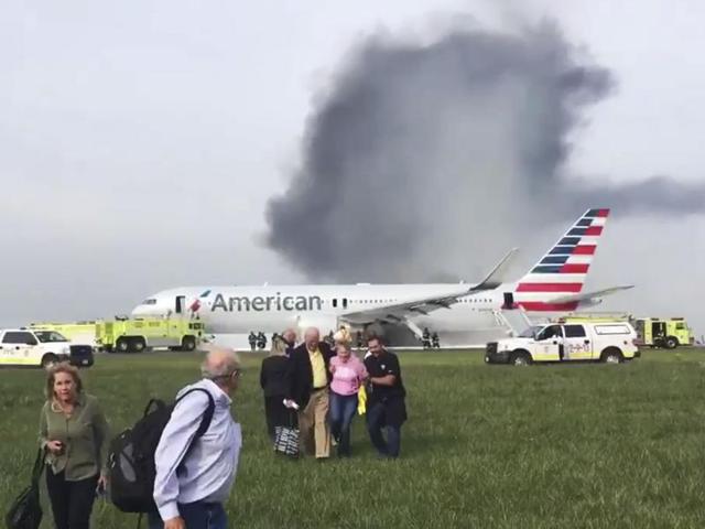 In this photo provided by passenger Jose Castillo, fellow passengers walk away from a burning American Airlines jet that aborted take off and caught fire on the runway at Chicago's O'Hare International Airport. (AP Photo) In this photo provided by passenger Jose Castillo, fellow passengers walk away from a burning American Airlines jet that aborted take off and caught fire on the runway at Chicago's O'Hare International Airport. (AP Photo)