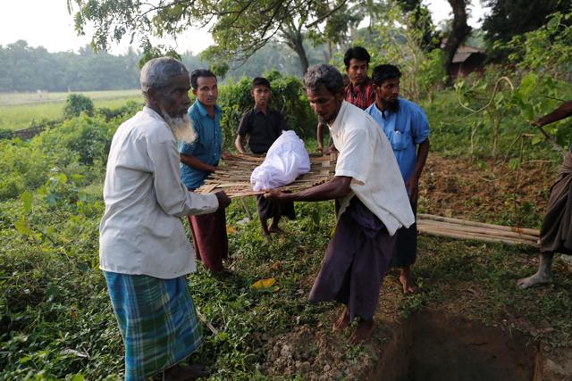 Men carry the body of an 11-year-old boy, who died due to illness, during his burial at a Rohingya village outside Maugndaw in Rakhine state, Myanmar. (REUTERS) Men carry the body of an 11-year-old boy, who died due to illness, during his burial at a Rohingya village outside Maugndaw in Rakhine state, Myanmar. (REUTERS)