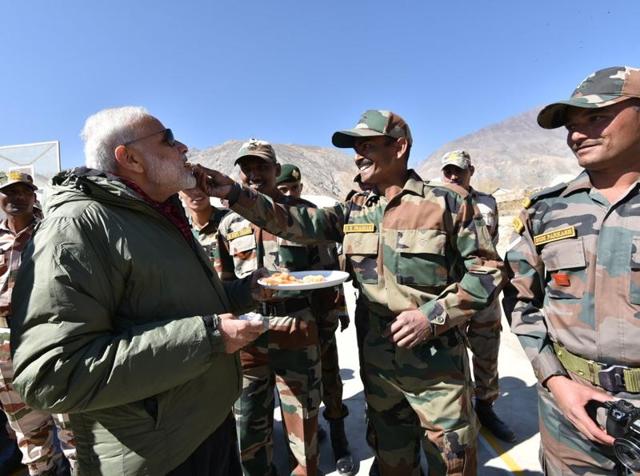 Prime Minister Narendra Modi with security personnel at Sumdo in Himachal Pradesh’s Kinnaur district. (Photo tweeted by @narendramodi) Prime Minister Narendra Modi with security personnel at Sumdo in Himachal Pradesh’s Kinnaur district. (Photo tweeted by @narendramodi)