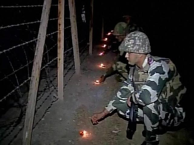 BSF jawans celebrate Diwali in RS Pura amid heightened tensions at the borded, in Jammu on Saturday. (PTI) BSF jawans celebrate Diwali in RS Pura amid heightened tensions at the borded, in Jammu on Saturday. (PTI)