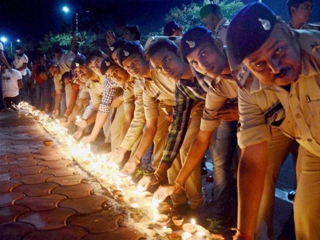 Police personnel light lamps as part of the campaign ’Ek Diya Shaheedon Ke Naam’ during a programme on the eve of Diwali, in Bhopal on Saturday. (PTI) Police personnel light lamps as part of the campaign ’Ek Diya Shaheedon Ke Naam’ during a programme on the eve of Diwali, in Bhopal on Saturday. (PTI)