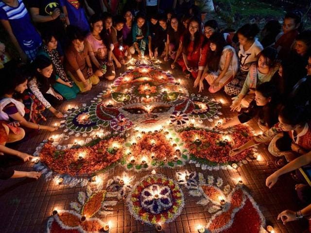Girls light earthen lamps during Diwali at Nalini Bala Devi Girls Hostel in Guwahati on Saturday. (PTI) Girls light earthen lamps during Diwali at Nalini Bala Devi Girls Hostel in Guwahati on Saturday. (PTI)