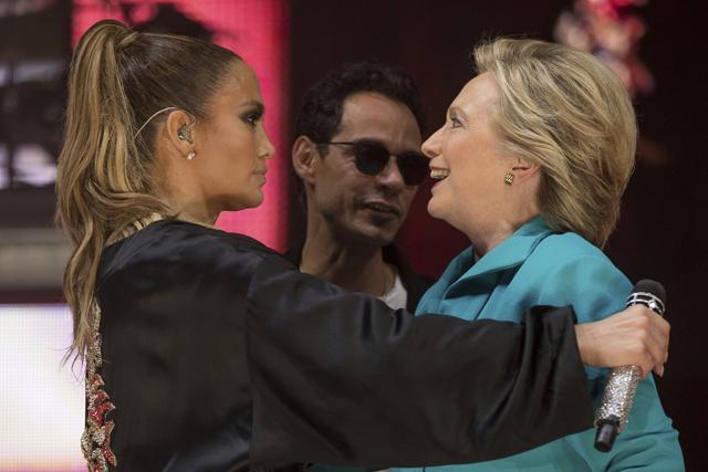 Clinton, accompanied by singer-songwriter Marc Anthony, hugs Jennifer Lopez at a Get Out The Vote performance at Bayfront Park Amphitheatre in Miami. (AP Photo) Clinton, accompanied by singer-songwriter Marc Anthony, hugs Jennifer Lopez at a Get Out The Vote performance at Bayfront Park Amphitheatre in Miami. (AP Photo)