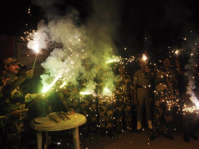 Border Security Force personnel light firecrackers to celebrate Diwali at the India-Bangladesh Akhaura checkpost in Agartala, Tripura on Saturday. (AFP) Border Security Force personnel light firecrackers to celebrate Diwali at the India-Bangladesh Akhaura checkpost in Agartala, Tripura on Saturday. (AFP)