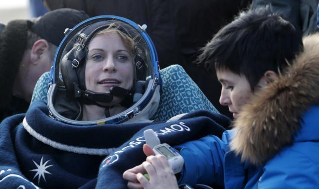 Specialists help US astronaut Kate Rubins shortly after landing of the Russian Soyuz MS space capsule.  (AP Photo)