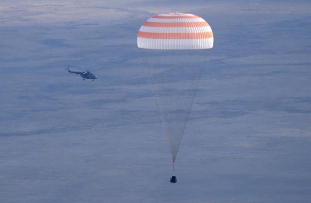A Russian Soyuz MS space capsule carrying US astronaut Kate Rubins, Russian cosmonaut Anatoly Ivanishin, and Japanese astronaut Takuya Onishi, descends.  (AP Photo)