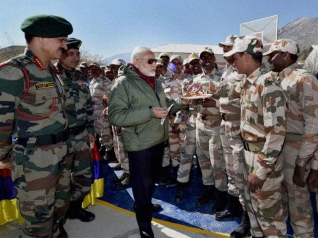 Prime Minister Narendra Modi offers sweets to jawans on the occasion of Diwali at Sumdo in Himachal Pradesh.(PTI Photo)