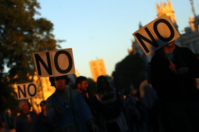 People carry a 'NO' signs during a demonstration against Spanish Prime Minister Mariano Rajoy and the Popular Party in Madrid, Spain. (AP Photo) People carry a 'NO' signs during a demonstration against Spanish Prime Minister Mariano Rajoy and the Popular Party in Madrid, Spain. (AP Photo)