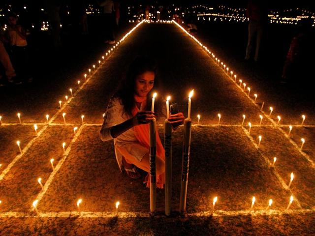 A girl lights candles inside a cricket stadium on the eve of Diwali, in Allahabad on Saturday. (Reuters) A girl lights candles inside a cricket stadium on the eve of Diwali, in Allahabad on Saturday. (Reuters)