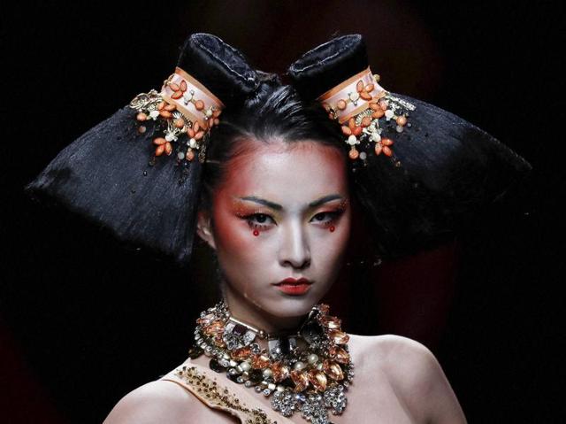 As much as we love the eccentricity of the Beijing fashion gala, we have to admit some of the looks presented stood out for their unusual headgear. (AP)
