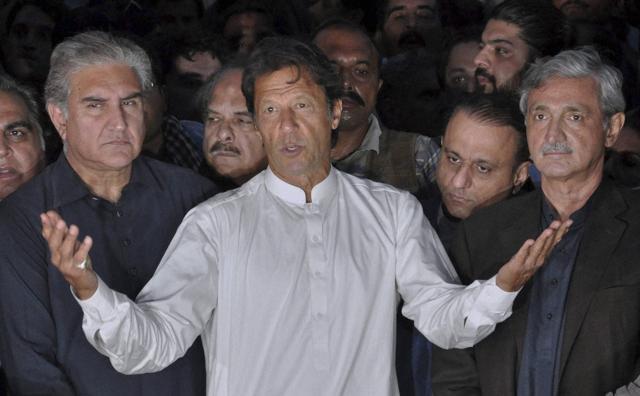 Politician Imran Khan, centre, speaks to journalists outside his residence in Islamabad on Sunday. (AP) Politician Imran Khan, centre, speaks to journalists outside his residence in Islamabad on Sunday. (AP)