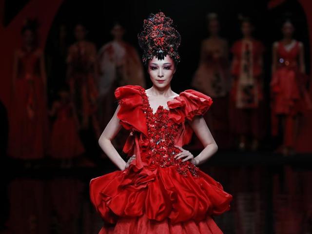 A model presents a creation by Chinese designer Zhang Yichao for Creative Rongchang Grass Cloth collection on stage during the Mercedes-Benz China Fashion Week in Beijing on Thursday. (AP)