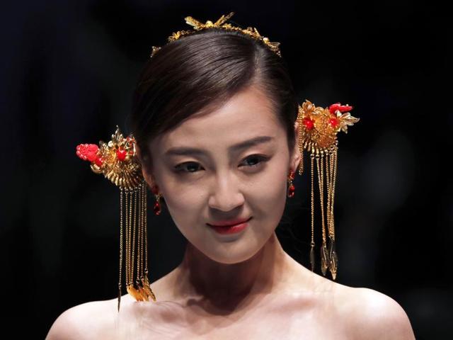 A model presents a creation by Famory on stage during the Mercedes-Benz China Fashion Week in Beijing on Wednesday. (AP)