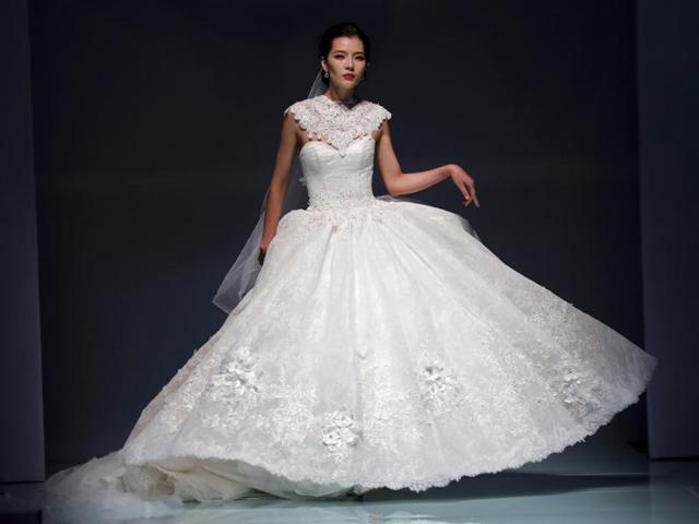A model displays a wedding dress created by Famory during the Mercedes-Benz China Fashion Week in Beijing on Wednesday. (AP)
